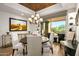 Elegant dining room with chandelier and access to patio at 9901 E Hidden Valley Rd, Scottsdale, AZ 85262