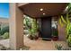 Elegant entryway with terracotta tile flooring and lush plants at 9901 E Hidden Valley Rd, Scottsdale, AZ 85262