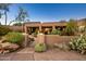 Inviting entryway with lush landscaping and a gated entrance at 9901 E Hidden Valley Rd, Scottsdale, AZ 85262