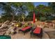 Outdoor patio with fire pit and comfortable lounge chairs at 9901 E Hidden Valley Rd, Scottsdale, AZ 85262