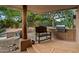 Outdoor kitchen and seating area on flagstone patio at 9901 E Hidden Valley Rd, Scottsdale, AZ 85262