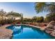 Inviting pool with flagstone decking and desert landscaping at 9901 E Hidden Valley Rd, Scottsdale, AZ 85262