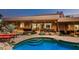 Stunning pool and patio with views into the home's interior at 9901 E Hidden Valley Rd, Scottsdale, AZ 85262