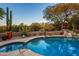 Inviting pool and spa with a flagstone patio and desert landscaping at 9901 E Hidden Valley Rd, Scottsdale, AZ 85262