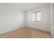 Simple bedroom with window and neutral colored walls at 9916 E Dolphin Cir, Mesa, AZ 85208