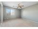 Bright bedroom with ceiling fan and mirrored closet doors at 9916 E Dolphin Cir, Mesa, AZ 85208