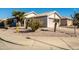 House exterior featuring desert landscaping and a two-car garage at 9916 E Dolphin Cir, Mesa, AZ 85208