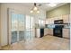 Kitchen with black appliances, granite countertops, and tiled floors at 9916 E Dolphin Cir, Mesa, AZ 85208