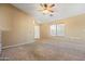 Living room featuring neutral walls, carpet, and a ceiling fan at 9916 E Dolphin Cir, Mesa, AZ 85208