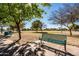 Green park bench under the shade of trees at 9916 E Dolphin Cir, Mesa, AZ 85208