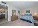 Bedroom with ensuite bathroom access and dresser at 10432 W El Capitan Cir, Sun City, AZ 85351