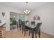 Bright dining area with a granite-top table and four black chairs at 10432 W El Capitan Cir, Sun City, AZ 85351