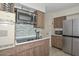 Modern kitchen with stainless steel appliances and tile backsplash at 10432 W El Capitan Cir, Sun City, AZ 85351