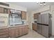 Kitchen features stainless steel appliances and wood cabinets at 10432 W El Capitan Cir, Sun City, AZ 85351