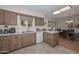 Kitchen with wood cabinets, white countertops, and stainless steel appliances at 10432 W El Capitan Cir, Sun City, AZ 85351