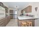 Kitchen boasts stainless steel appliances and wood cabinets at 10432 W El Capitan Cir, Sun City, AZ 85351