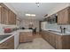 View of kitchen with wood cabinets, appliances, and a breakfast bar at 10432 W El Capitan Cir, Sun City, AZ 85351