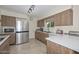 Kitchen with stainless steel appliances and wood cabinets at 10432 W El Capitan Cir, Sun City, AZ 85351