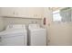 Bright laundry room, featuring a washer and dryer, and ample storage at 10432 W El Capitan Cir, Sun City, AZ 85351