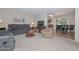 Open living and dining area with gray couches and a TV at 10432 W El Capitan Cir, Sun City, AZ 85351