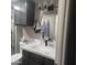 Bathroom with marble countertop and dark cabinets at 10544 W Campana Dr, Sun City, AZ 85351