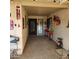 Covered entryway with decorative door, red flower pots, and whimsical decor at 10544 W Campana Dr, Sun City, AZ 85351