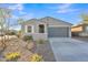 Single story home with gray exterior and landscaped yard at 11026 S 55Th Ln, Laveen, AZ 85339