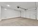 Bright, empty two-car garage with automatic garage door opener at 11026 S 55Th Ln, Laveen, AZ 85339