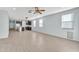 Bright living room with wood-look tile flooring and ceiling fan at 11026 S 55Th Ln, Laveen, AZ 85339