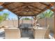 Relaxing backyard patio with covered gazebo and comfortable seating at 12211 N 57Th St, Scottsdale, AZ 85254