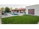 Landscaped backyard with pool, patio, and detached garage at 12211 N 57Th St, Scottsdale, AZ 85254