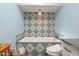 Relaxing bathroom with a freestanding soaking tub and patterned tile feature wall at 12211 N 57Th St, Scottsdale, AZ 85254