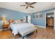 Blue bedroom with a wooden bed frame and access to a walk-in closet at 12211 N 57Th St, Scottsdale, AZ 85254