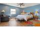 Bedroom with blue walls, wooden bed frame, and access to backyard at 12211 N 57Th St, Scottsdale, AZ 85254