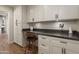 Butler's pantry with white shaker cabinets, dark countertop, and built-in workspace at 12211 N 57Th St, Scottsdale, AZ 85254