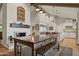 Spacious dining room features a large wooden table with bench seating, and views into the kitchen and Gathering room at 12211 N 57Th St, Scottsdale, AZ 85254