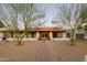 Single story home with red tile roof, walkway, and mature trees at 12211 N 57Th St, Scottsdale, AZ 85254