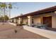 House with covered patio, metal table and chairs, and mature trees at 12211 N 57Th St, Scottsdale, AZ 85254