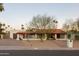 Ranch style home with red tile roof, landscaping, and long driveway at 12211 N 57Th St, Scottsdale, AZ 85254