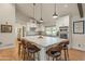 Modern kitchen with large island, stainless steel appliances, and white shaker cabinets at 12211 N 57Th St, Scottsdale, AZ 85254