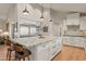 Modern kitchen with large island, stainless steel appliances, and white shaker cabinets at 12211 N 57Th St, Scottsdale, AZ 85254