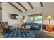 Living room with hardwood floors, a blue sofa, and wood beam ceiling at 12211 N 57Th St, Scottsdale, AZ 85254