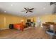 Spacious living room with hardwood floors, orange couch, and a ceiling fan at 12211 N 57Th St, Scottsdale, AZ 85254