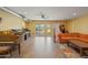 Living room features hardwood floors, orange couch, and a grand piano at 12211 N 57Th St, Scottsdale, AZ 85254