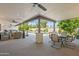 Spacious covered patio with pool view, comfortable seating, and dining area at 12211 N 57Th St, Scottsdale, AZ 85254