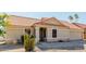 Tan house with a red tile roof, a two-car garage, and a cactus in the front yard at 1237 E Heather Ave, Gilbert, AZ 85234