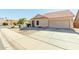 Tan house with a red tile roof and a two-car garage, viewed from the street at 1237 E Heather Ave, Gilbert, AZ 85234