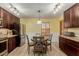 Kitchen with dark wood cabinets, granite countertops, and a breakfast nook at 1237 E Heather Ave, Gilbert, AZ 85234