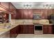 Kitchen with dark wood cabinets, granite countertops, and stainless steel appliances at 1237 E Heather Ave, Gilbert, AZ 85234