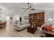 Living room with light beige sofas, wood flooring, and a large bookcase at 1237 E Heather Ave, Gilbert, AZ 85234